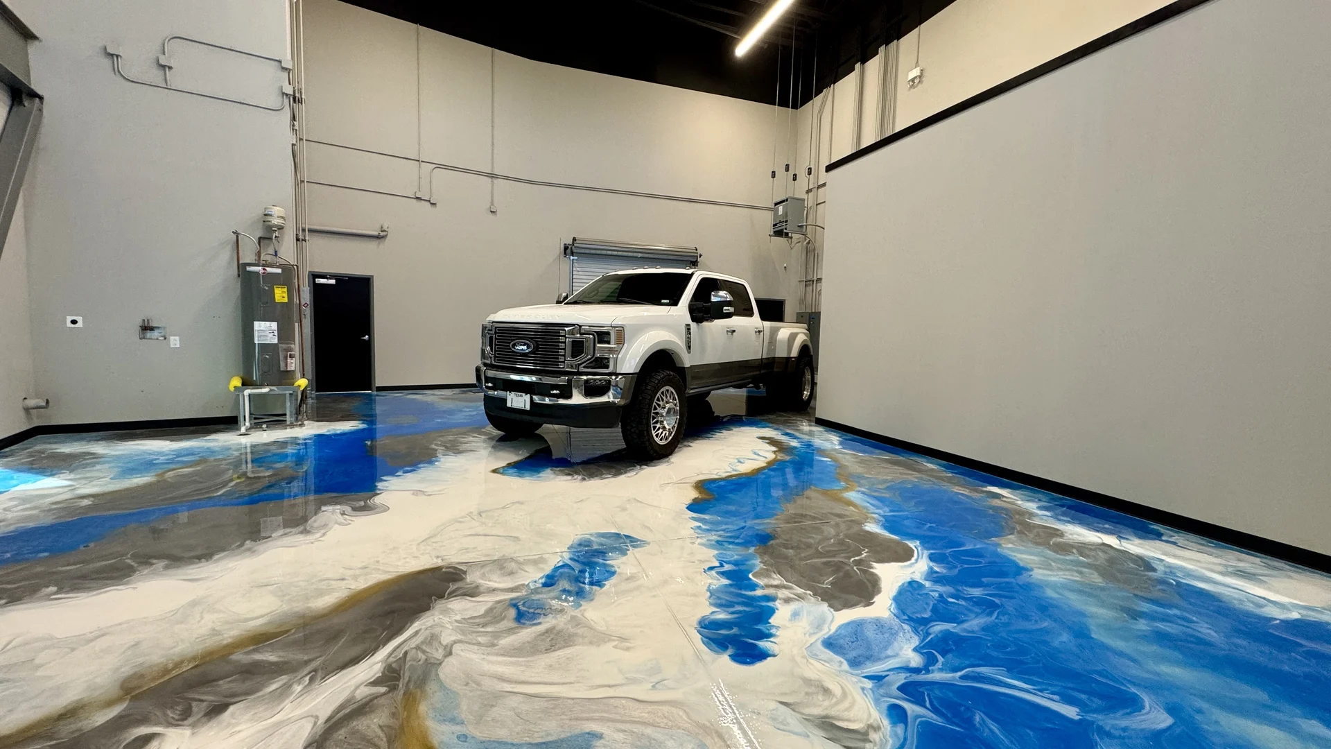Metallic epoxy floor with blue and gold swirl pattern in commercial space