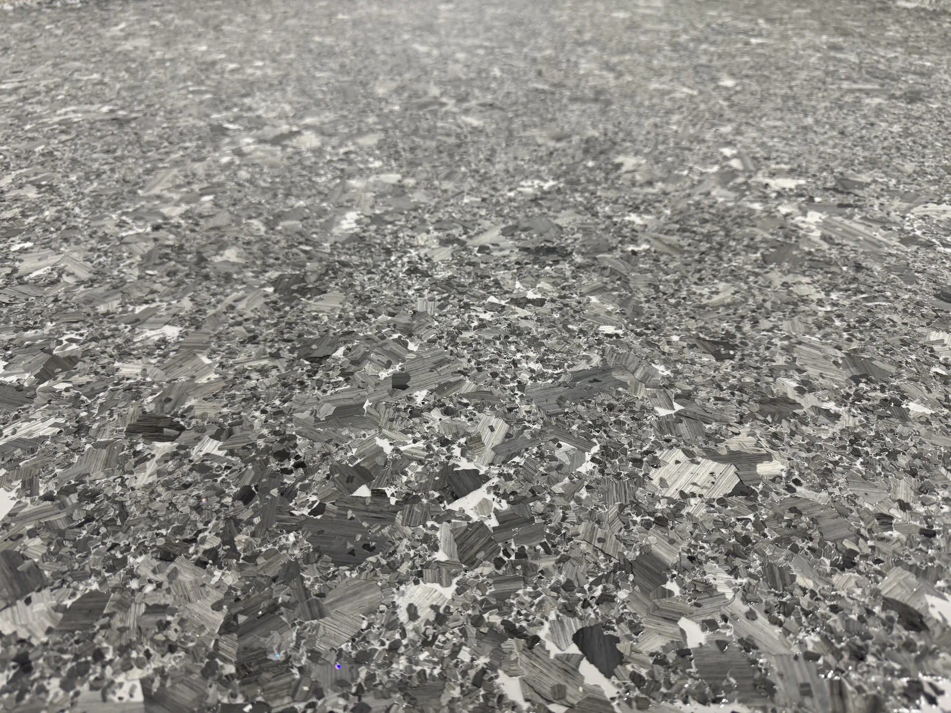 Close-up of premium brindle flake epoxy showing mirror-like gloss finish